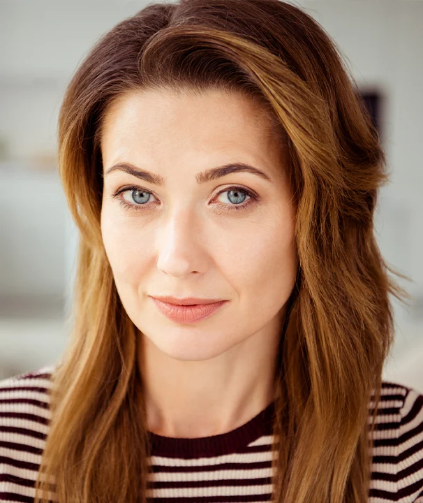 Woman with smooth natural facial contours and youthful appearance following deep plane facelift in New York